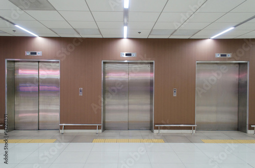  closed metal office building elevator doors in modern building