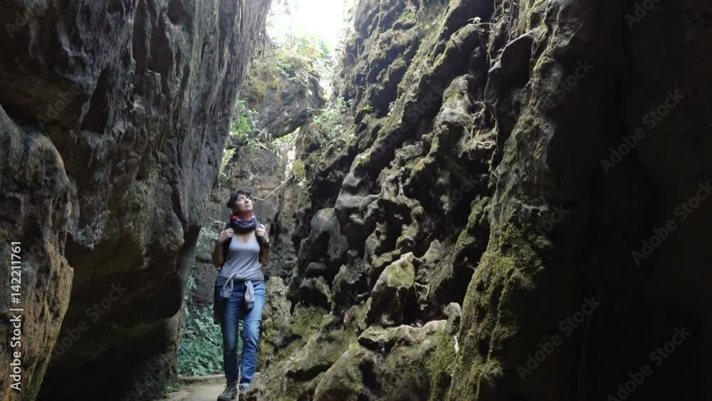 A woman goes into a narrow cleft in the mountains. Full HD slow motion stock footage.
A woman goes into a narrow cleft in the mountains. Full HD slow motion stock footage.