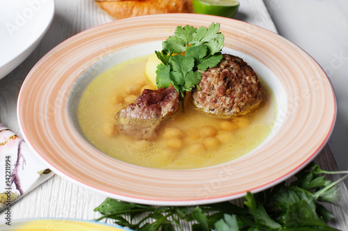 Soup with chickpeas and meatballs, plate, still life