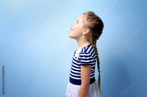 Cute little girl on color b...