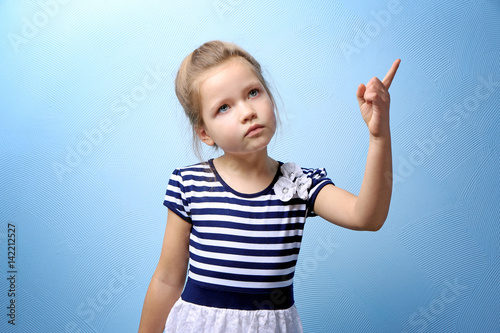 Cute little girl on color b...