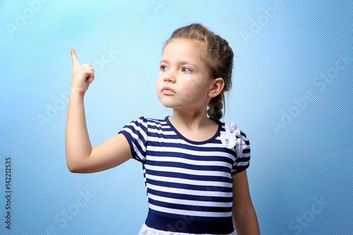Cute little girl on color b...