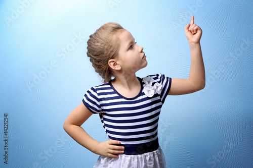 Cute little girl on color b...