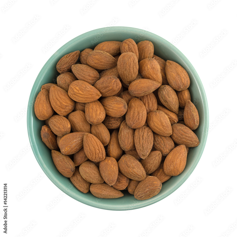 Raw natural almonds in a bowl isolated on a white background. Raw natural almonds in a bowl isolated on a white background.