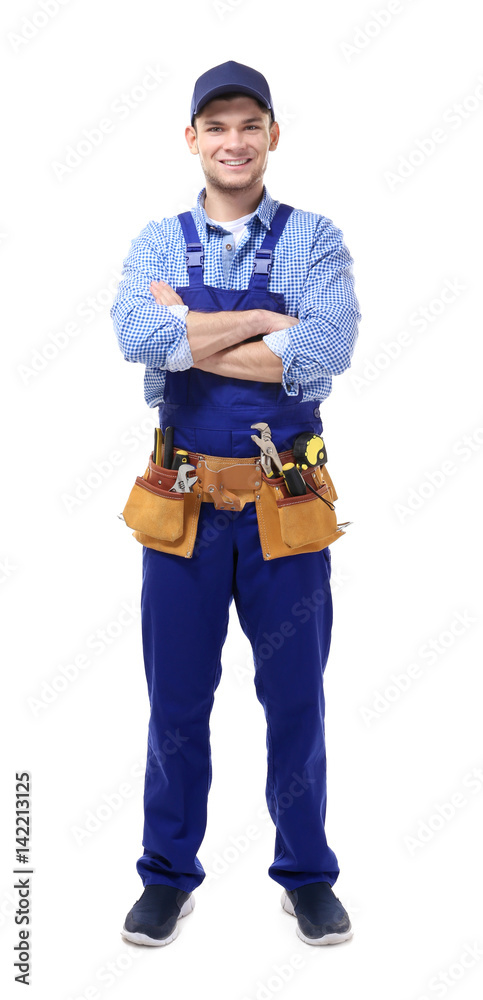 Young handsome plumber with crossed hands on white background