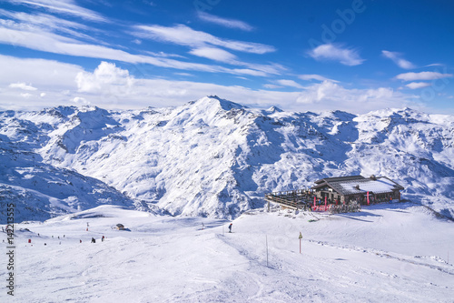 view of ski resort in mountains. Ski slopes. Rest in mountains in the winter. Skiing and snowboards.