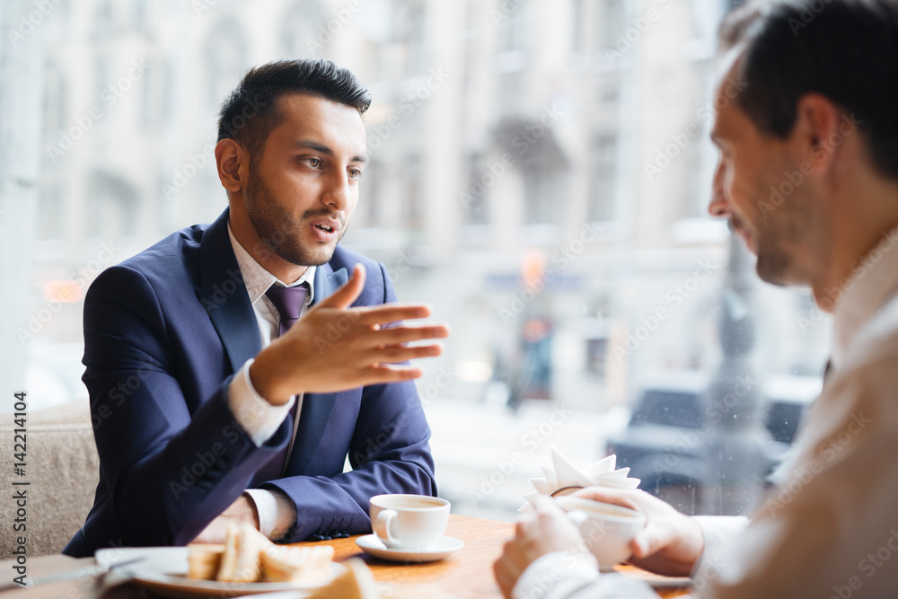 Businessmen brainstorming and discussing working plans Businessmen brainstorming and discussing working plans