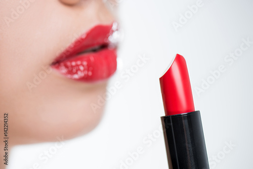 Woman holding red lipstick
