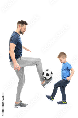 Handsome man and his son playing football on white background