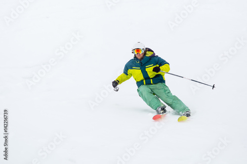 skier skiing on fresh snow on ski slope on Sunny winter day in the ski resort in Georgia