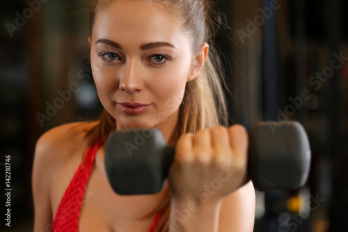 Sporty young woman work out biceps