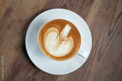 latte art coffee on wood background.Vintage Style