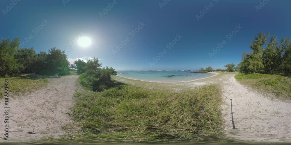 360 VR video. Bright sun shining over the blue ocean with grassy beach. Family with child making their way along the coast. Tourists having a walk on Mauritius Island 360 VR video. Bright sun shining over the blue ocean with grassy beach. Family with child making their way along the coast. Tourists having a walk on Mauritius Island