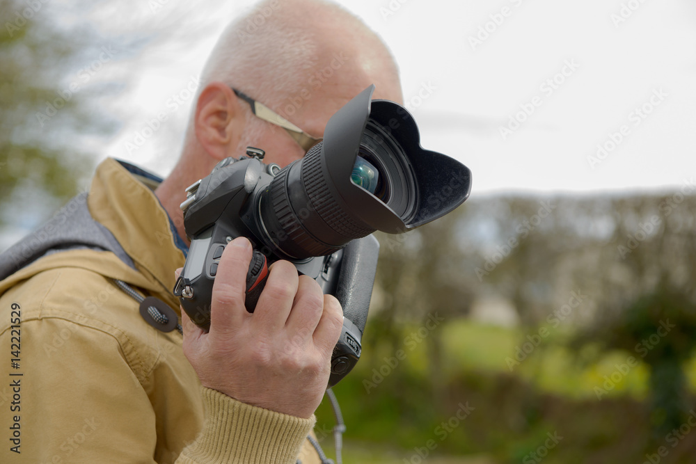 photographer holding his photo camera