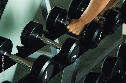Dumbbells and female hands
