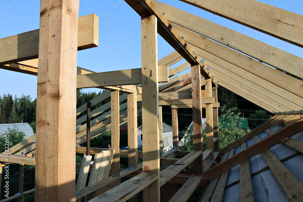 Installation of wooden beams at construction