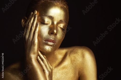 Portrait unearthly Golden girls, hands near the face. Very delicate and feminine. The eyes are closed © gal2007