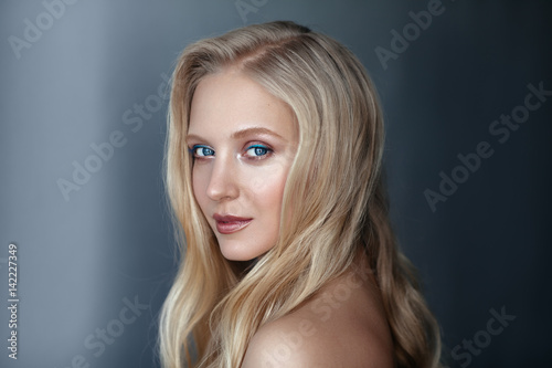 Beauty portrait of nordic natural blonde woman on dark background