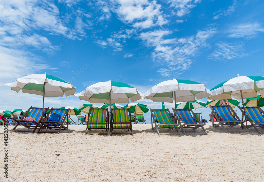 Beach chairs with umbrella with blue sky on tropical beach at Koh Tao, Thailand.