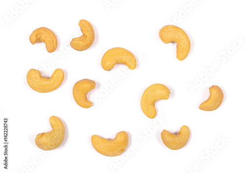 Unshelled roasted cashew nuts isolated on white background, top view