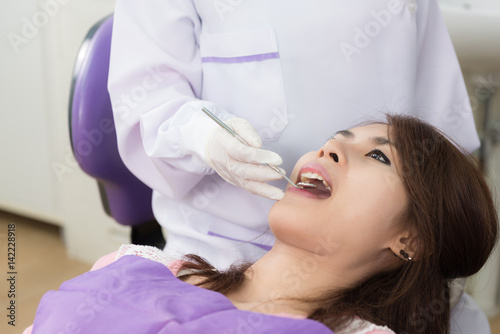Dentist examine asian woman patient