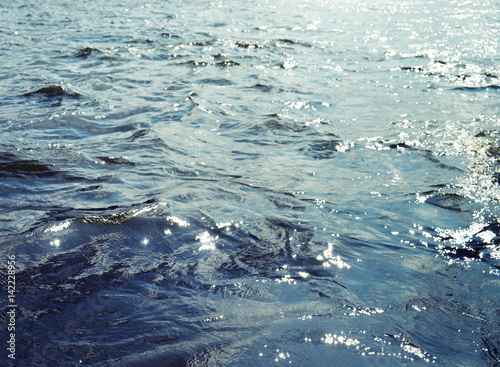 Water surface with ripples and sunlight reflections © wedninth