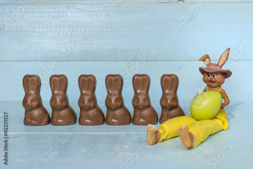 Chocolate Easter rabbits on a blue wooden background