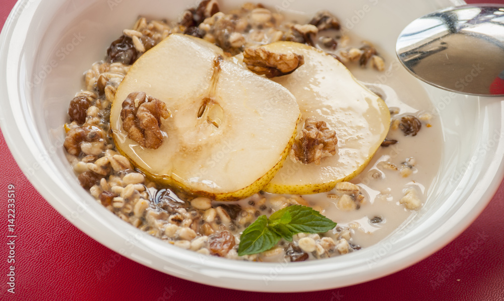 Oatmeal with pear and walnuts in the bowl