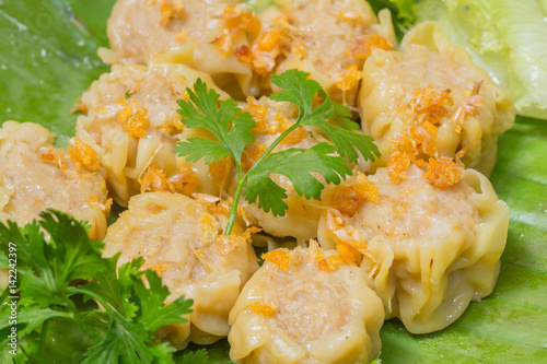 Steamed Chinese Dumpling Shumai served in Thai style with fried garlic and Coriander leaves. photo