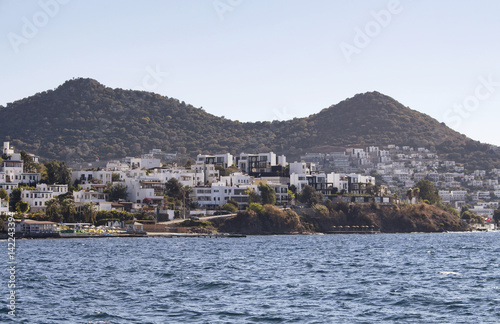 Village full of summer houses in Yalikavak area in Bodrum peninsula. Architectural style of the region is all white homes. © theendup
