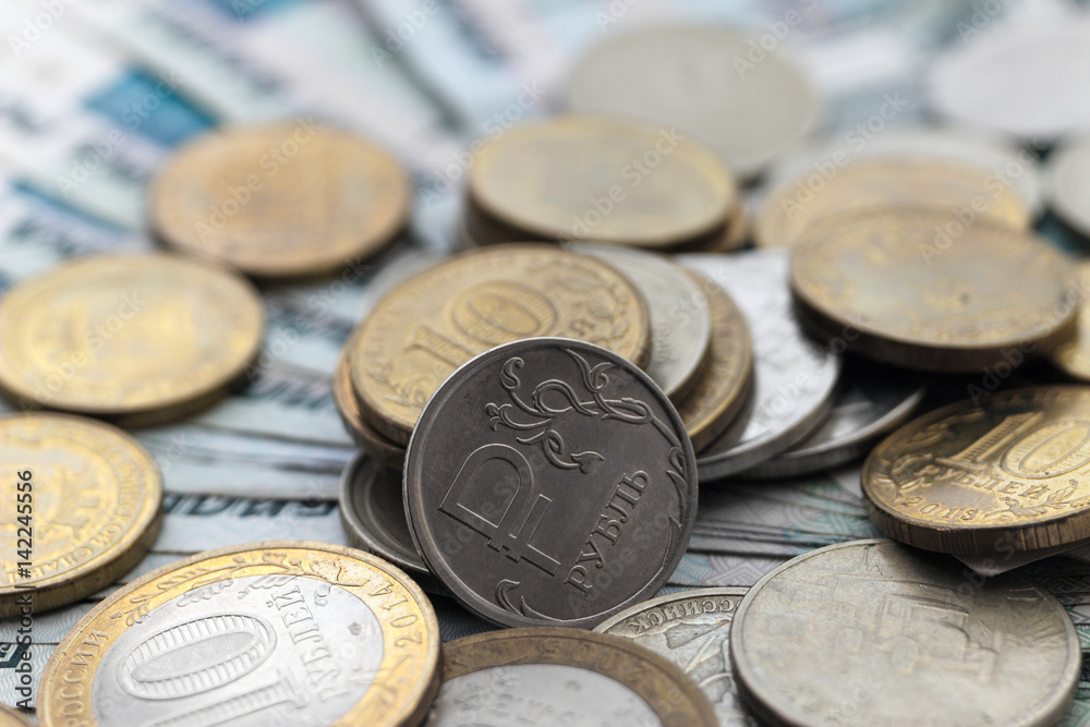 Russian coins on a background of paper money Russian coins on a background of paper money