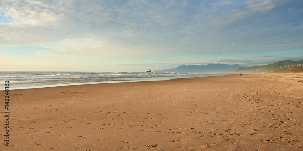Oregon Coast at Sunset. Panoramic view of a beach and ocean near Barview Jetty. USA Pacific Northwest.