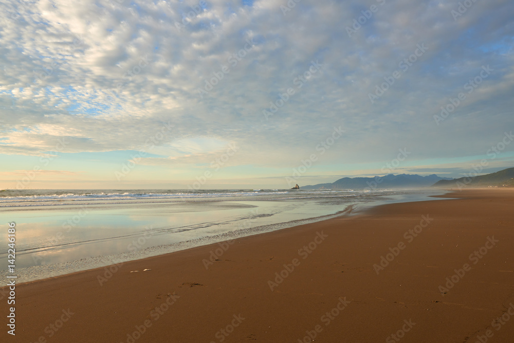 Oregon Coast at Sunset. View of a beach and ocean near Barview Jetty. USA Pacific Northwest. Oregon Coast at Sunset. View of a beach and ocean near Barview Jetty. USA Pacific Northwest.