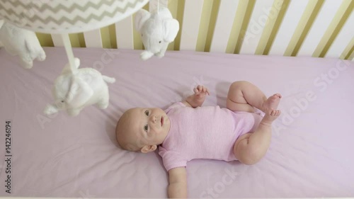 Wallpaper Mural Adorable Newborn Baby Girl in Crib Looking Up at Mobile Overhead Torontodigital.ca