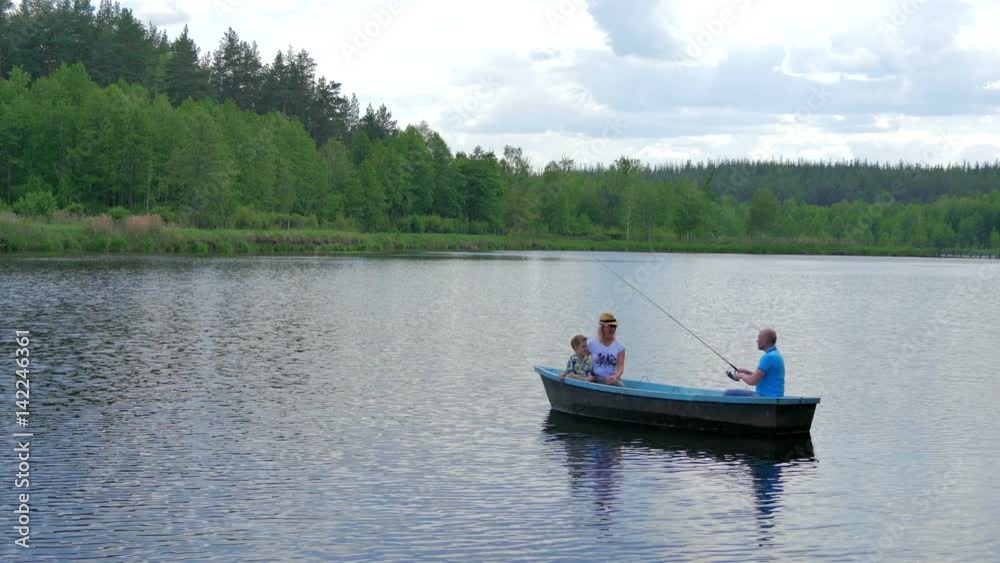 The father fishing with family on the river The father fishing with family on the river