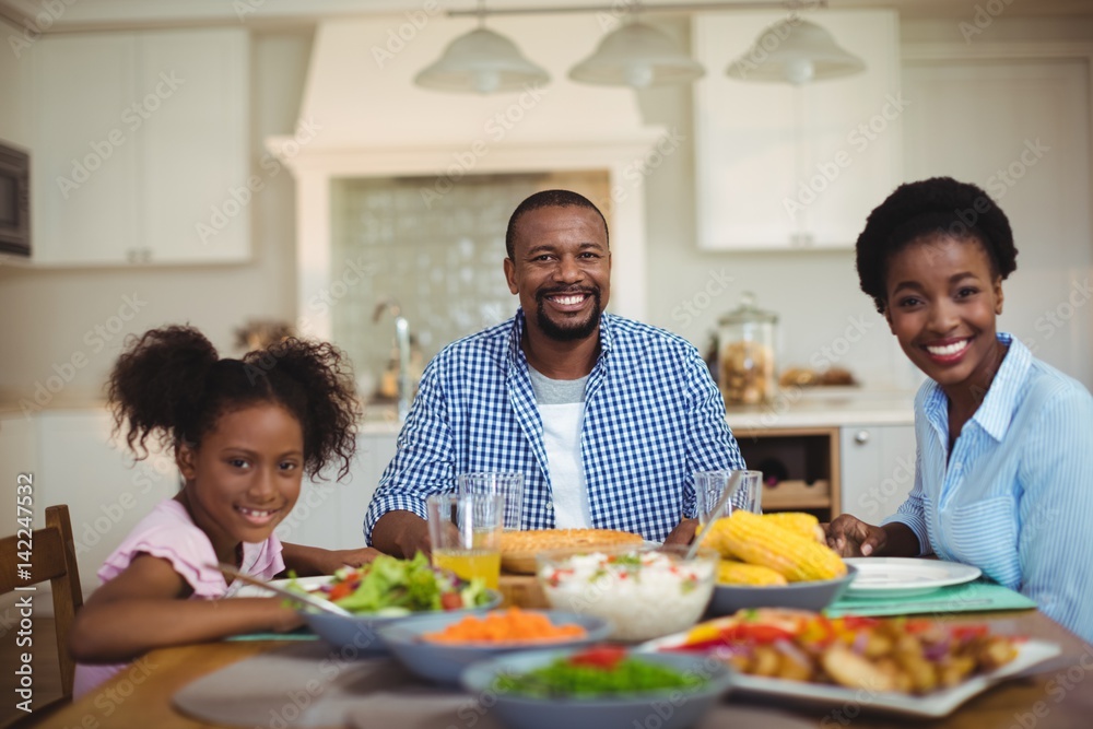 Portrait of family having meal on dinning table at home Portrait of family having meal on dinning table at home