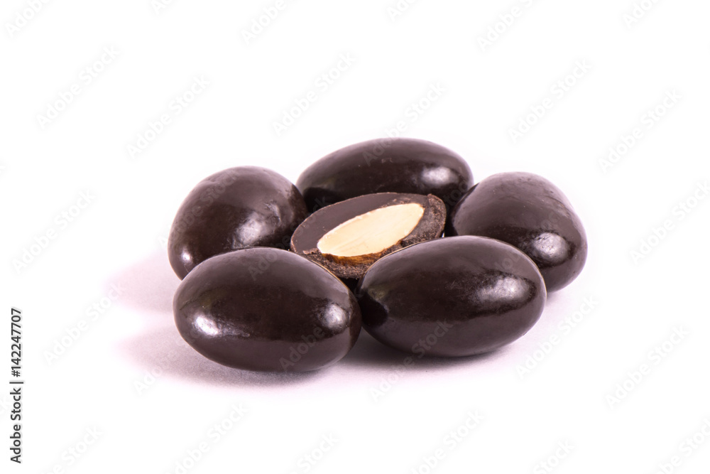 group of nuts in chocolate on a white background. Part cut in half.