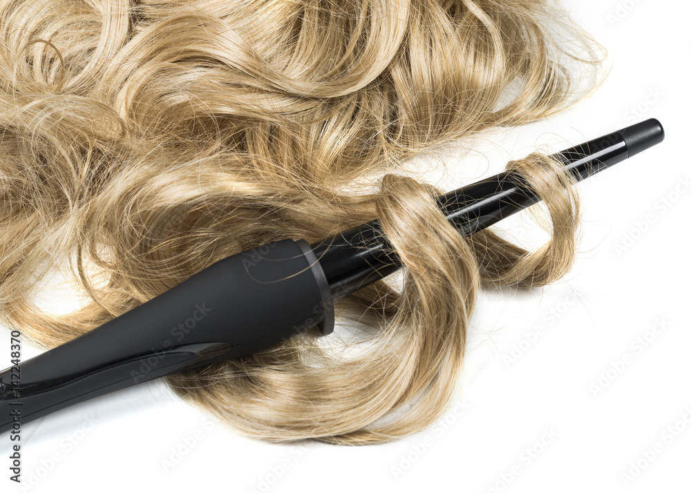 Naklejka premium woman long haired making hairstyle iron.