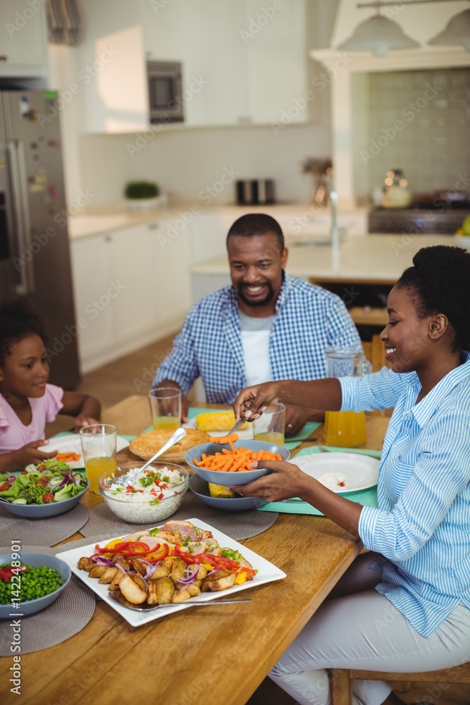 Family having meal on dinning table at home