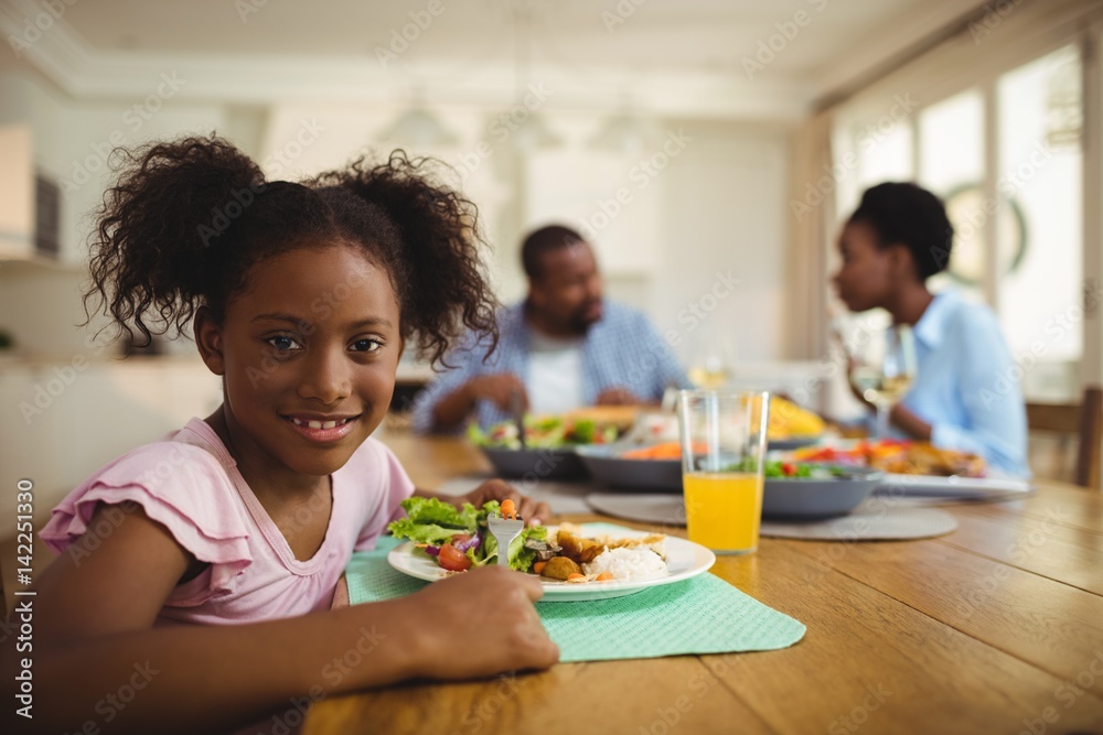 Portrait of girl having meal on dining table Portrait of girl having meal on dining table