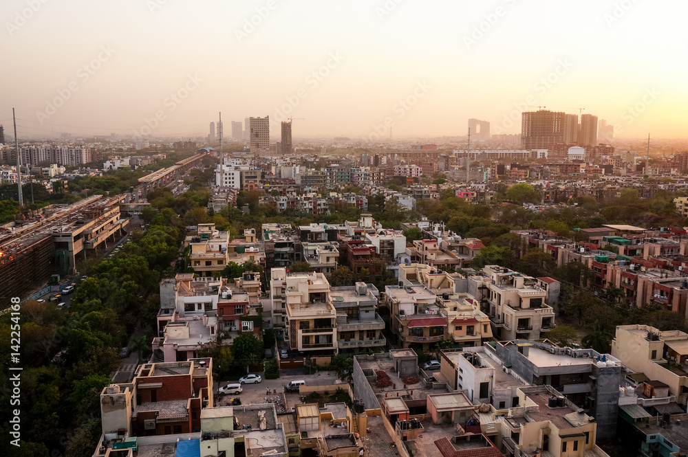 Noida cityscape at dusk with the under construction buildings and golden sunset light