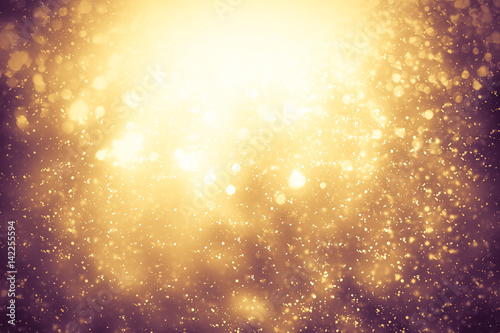 Golden abstract sparkles or glitter lights. Festive gold background. Defocused circles bokeh or particles. Template for design © Bokehstore
