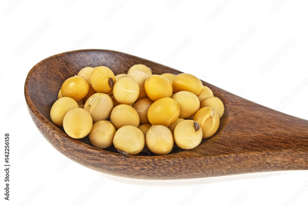 Soybeans in wooden spoon on a white background Soybeans in wooden spoon on a white background