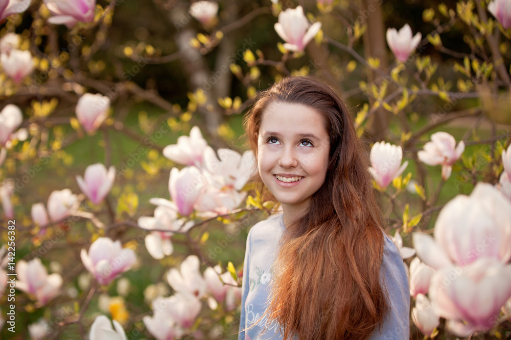 Young teenager girl in the spring park