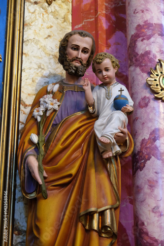 Saint Joseph holding baby Jesus statue at the altar in the church of Saint Catherine of Alexandria in Krapina, Croatia.