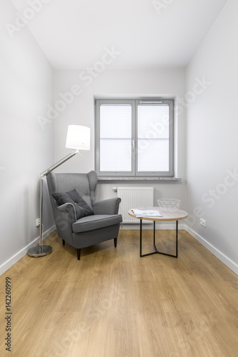 Grey armchair with small table