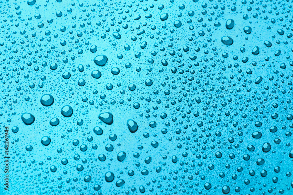 Drops of water on a color background. light blue