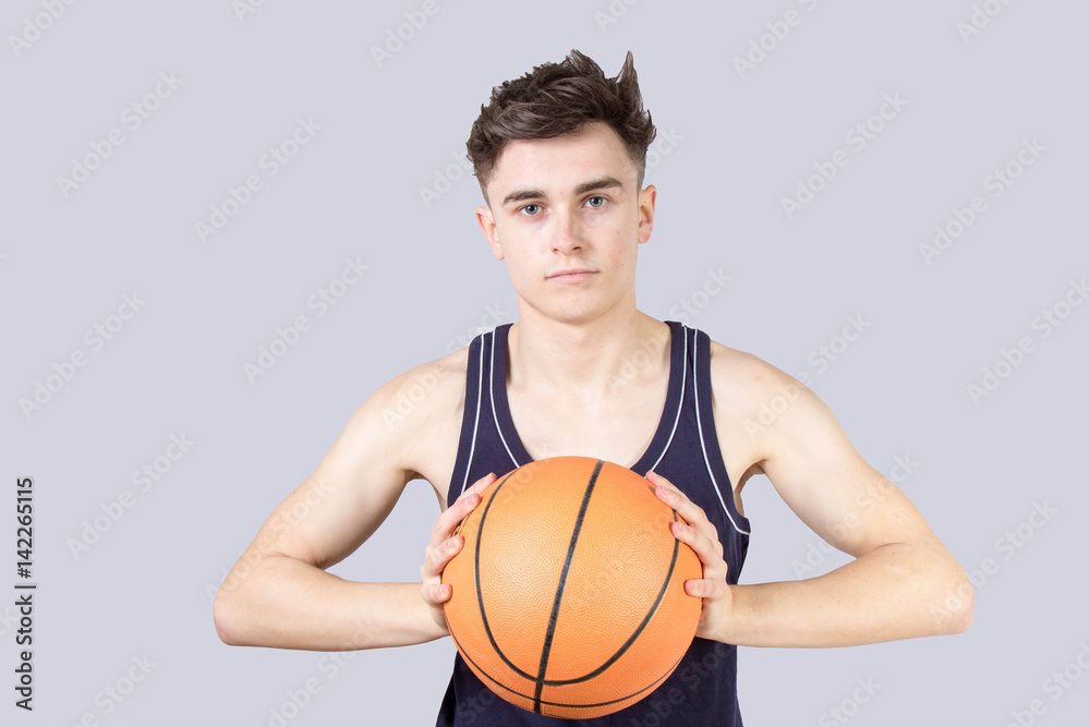 Caucasian teenage boy holding a basketball isolated Caucasian teenage boy holding a basketball isolated