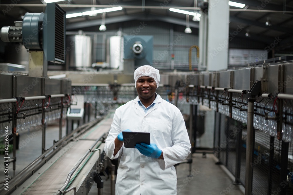 Factory engineer using digital tablet in the factory