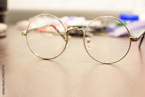 Clear circular glasses on the table with blurry background